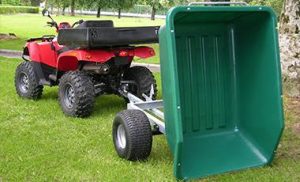 quad bike with a green tipping trailer attached